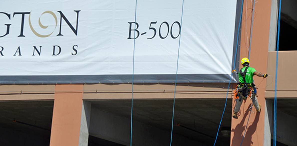 large banner hung from a parking garage in las vegas